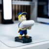 61s6wWEAACL._AC_SL1500_.jpg Cableguys Minis Fallout Big League Vault Boy Phone Stand & Earbuds Holder - Novelty Phone Stand for Desk and Bedside, In Ear Headphone Holder for Smartphone & Small Devices, Desk Decor Accessories