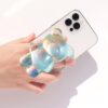 71ogNIvfKzL._AC_SL1500_.jpg On The Grip 3D Gummy Bear Style Expandable Collapsible Mobile Phone Grip Stand Holder for Smartphone Tablet Cell Phone Accessory (Holographic)
